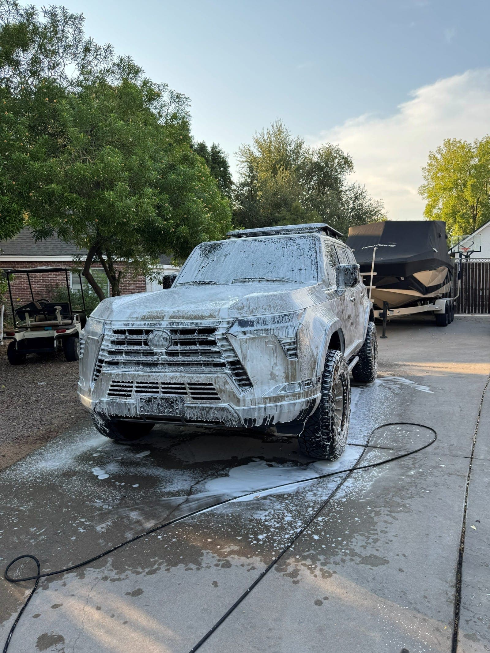 SUV covered in thick foam during a Ghostline hand wash